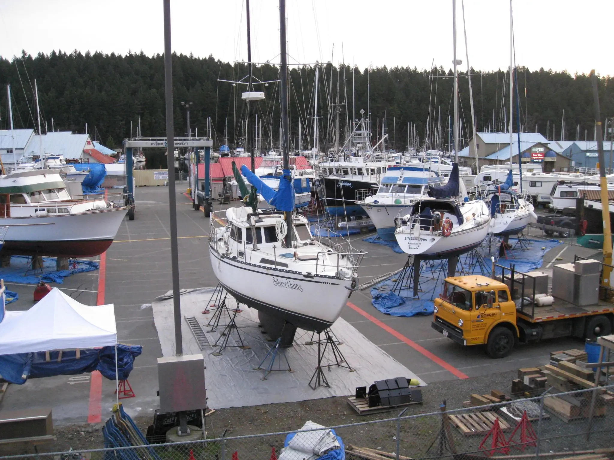 small sailing boat lifted on pier