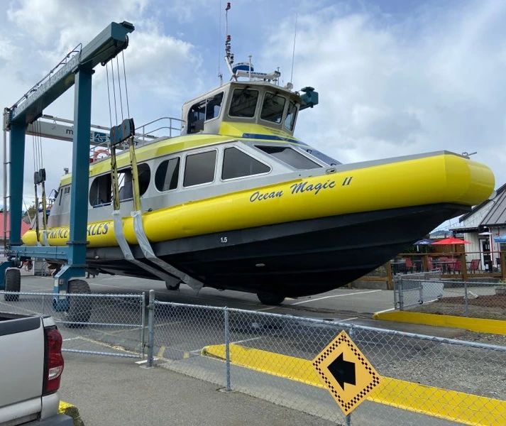 Boat with yellow sides lifted for repairs
